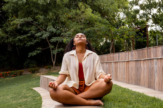 Serene Woman Meditating on Garden Steps