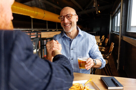 Bro handshake at bar