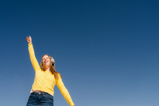 happy young woman listening and dancing  to music