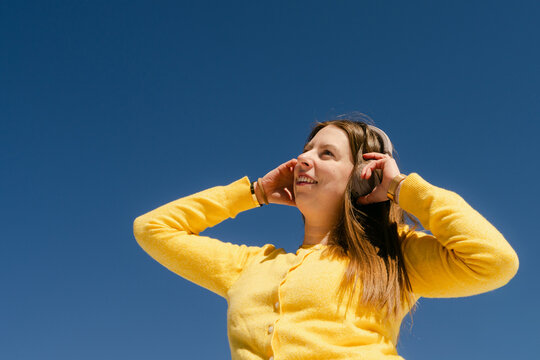 happy young woman listening to music in the sunshine 