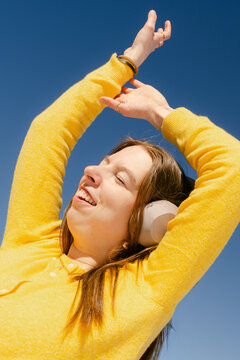 happy young woman listening and dancing  to music