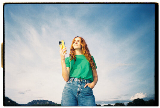Happy woman with phone blue skye