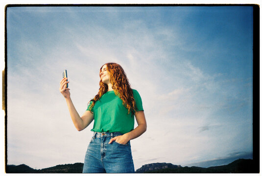 Happy woman with phone blue skye