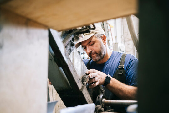 Craftsman working on knife blade in workshop