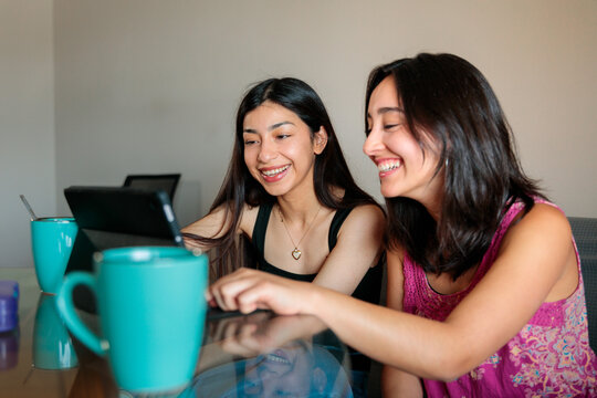 Friends Using Tablet While Studying