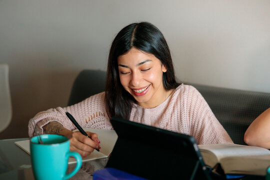 Student Taking Notes with Tablet