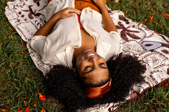 Top-Down View of Woman Relaxing on Blanket