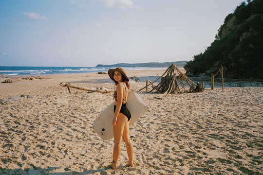 Woman with bodyboard on the beach 