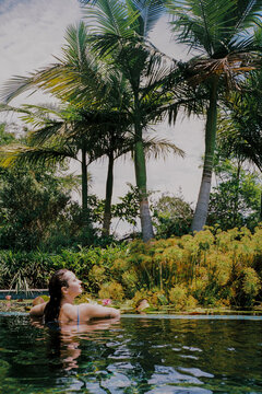 Woman in the pool in the tropical setting