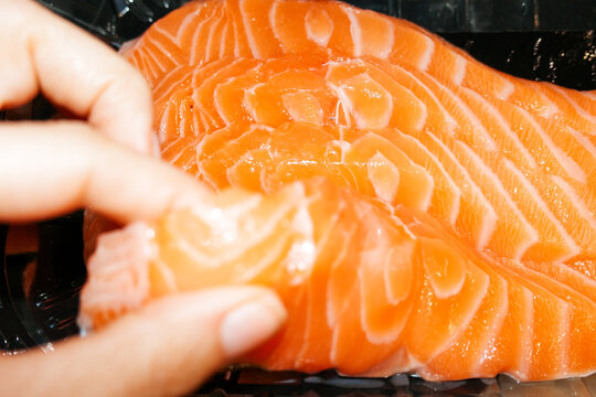 Salmon Being Handled in a Kitchen. Flash food