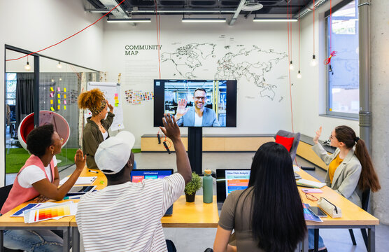 Modern workplace with virtual meeting of multiethnic coworkers