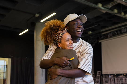 Joyful embrace in a modern studio setting