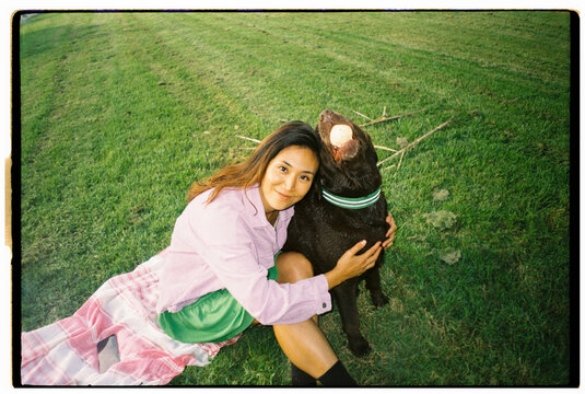 Analog HAPPY Woman playing with dog IN PARK