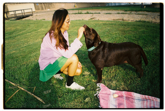 Analog Woman playing with dog IN PARK