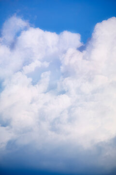 Fluffy white clouds and blue sky background