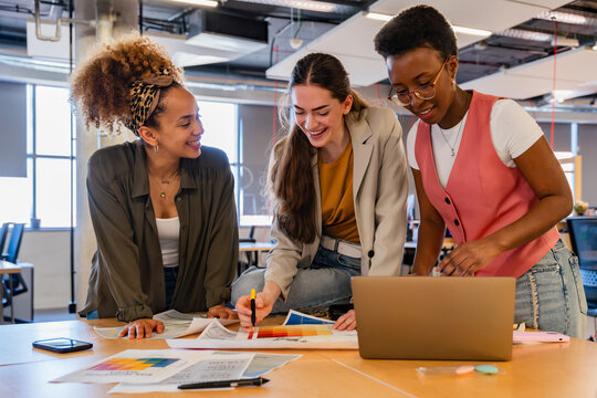 Coworkers collaborating in creative office setting
