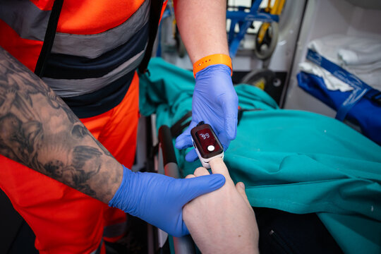 Paramedic Checking Patient Oxygen Level