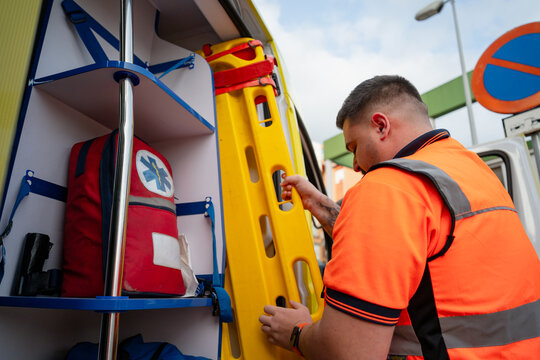 Paramedic Taking Spine Board From Ambulance