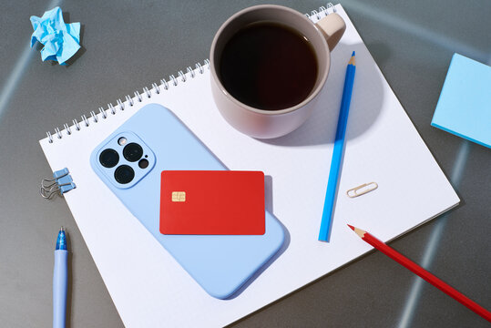 Coffee, phone on a sketchbook with supplies