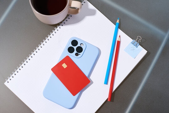 Items on a desk with a phone and a credit card