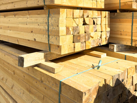 Stacked Construction Timbers and Wooden Planks Bound with Straps