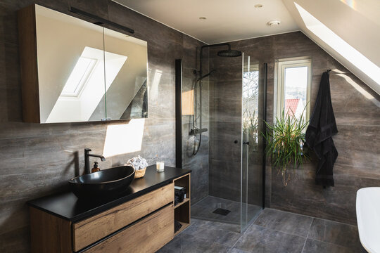 Modern luxury bathroom interior with dark stone walls