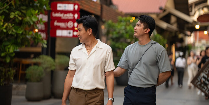 Gay couple enjoying city walk together, exploring shopping street