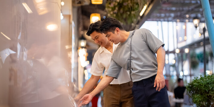 Couple enjoying urban shopping experience, smiling and picking food