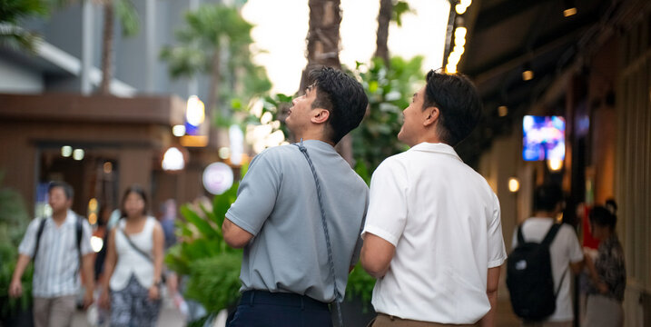 Gay couple enjoying shopping street life, exploring city together