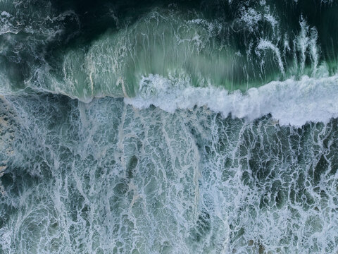 Aerial View of Ocean Waves Crashing on Shore 