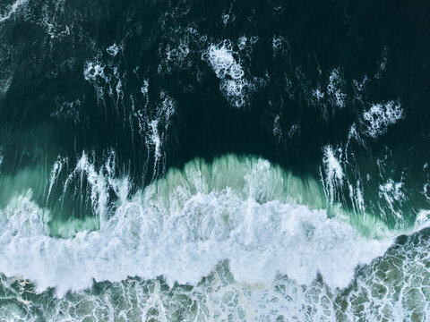Aerial View of Ocean Waves Crashing on Shore 