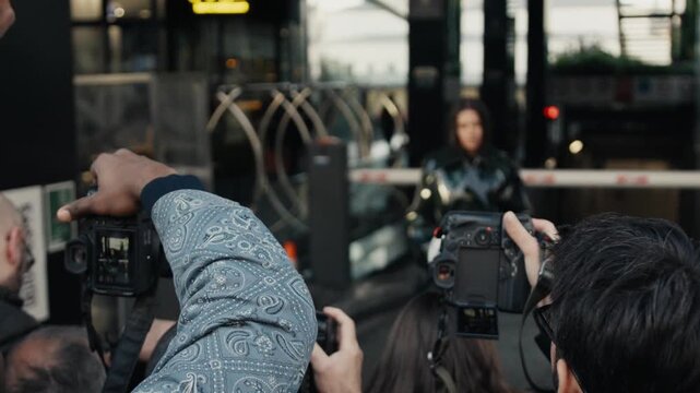 Paparazzi photographers taking pictures of a celebrity