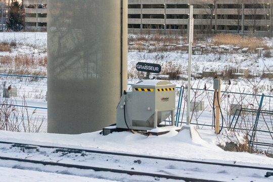 Canada, Montreal, 26 December 2025 : Winter scene with railway greaser machine in snowy landscape