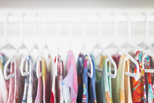 toddler girl dresses on hangers in organized wardrobe shallow depth of field