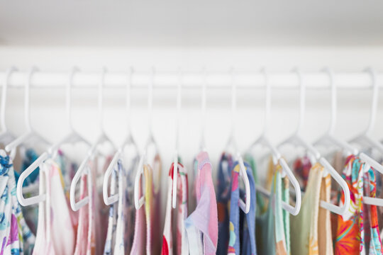 toddler girl dresses on hangers in organized wardrobe shallow depth of field