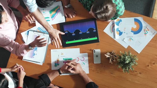 Top down view of multicultural business group putting hand together to celebrate collaboration or successful project. Close up of smart marketing team working together at meeting room. Convocation.