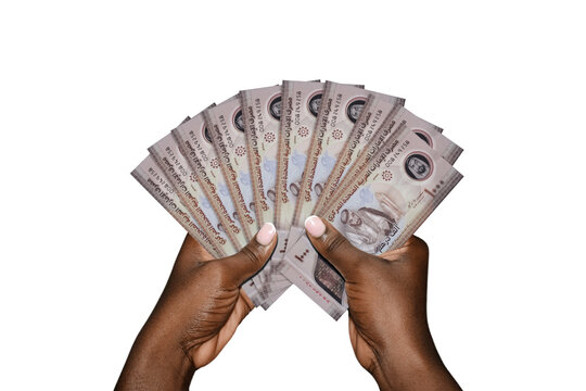 Hands holding a fan of United Arab Emirates 1,000 Dirham polymer banknotes. The image highlights wealth, banking, and the official UAE currency notes featuring Sheikh Zayed and space exploration theme