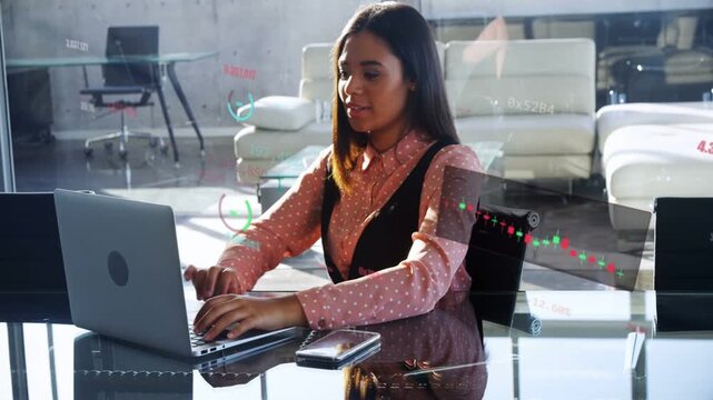 Woman typing on laptop with phone in office activating finance charts closing PC after ending work
