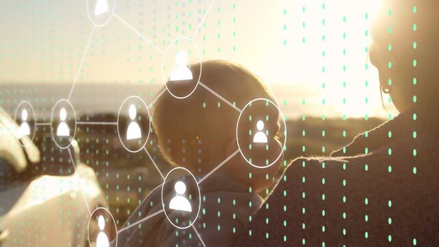 Mom holding baby by car at sunset neck marker appearing and expanding network showing tech links