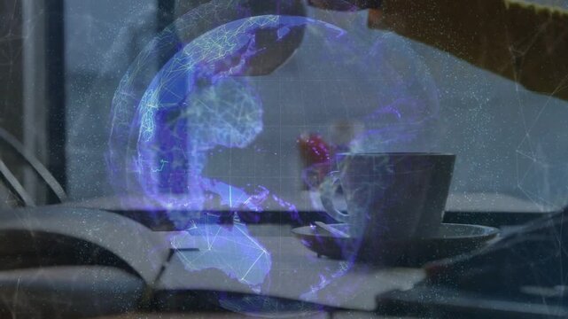 Hand reaching from right, grasping teapot, tilting and pouring, filling cup while globe growing