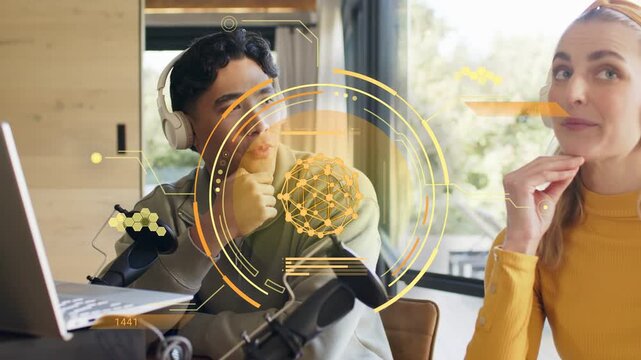 Male co-host speaking into mic and gesturing, female listening, yellow AR HUD guiding podcast