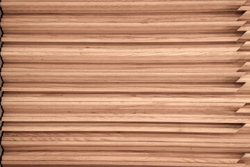 Fototapeta premium Stack of polished wooden planks with a natural grain texture. The boards are arranged horizontally with mitered edges visible on the right side. Ideal for carpentry and interior design background.