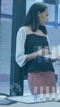 Vertical video: Woman holding doc at table glancing as matching sheet with business bars appearing