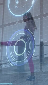 Vertical video: Woman lifting right knee, stretching hamstring for fitness, blue HUD tracking hip