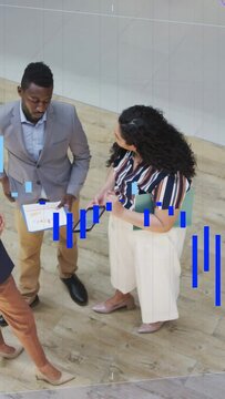 Vertical video: Woman tapping tab man pointing report blue bars sweeping across checking biz charts
