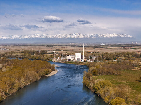 Aerial view of the Enrico Fermi Nuclear Power Plant situated along the Po River with the snow-capped Alps in the background Trino, Piemonte, Italy.