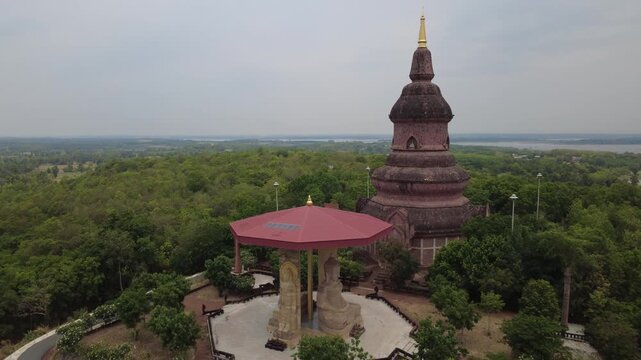Wat Phuttha Nimit (Wat Phu Khao) Golden Thai pagoda and ancient Buddhist temple architecture stand tall against a morning sky as a landmark of Asian culture 