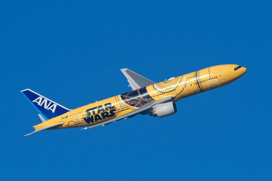 All Nippon Airways (ANA) Boeing 777-200ER (JA743A) passenger plane in special "C-3PO ANA JET" livery taking off from Haneda Airport.