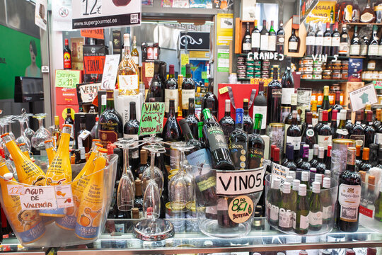 VALENCIA, SPAIN - APRIL 9, 2025: Bottles of Spanish wine fill a market stall in Valencia,on regional wine culture, spanish wine exports, food shopping and everyday commerce in Spain.