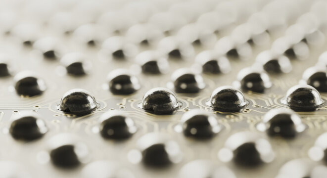 Macro close-up of a ball grid array BGA on a modern printed circuit board for computer hardware manufacturing